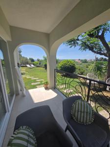 a porch with two chairs and a balcony with a view at Apartment Mia in Rab