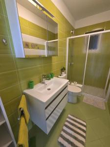 a bathroom with a sink and a shower and a toilet at Apartment Mia in Rab +38 photos