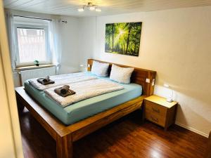 a bedroom with a bed with two teddy bears on it at Bauernhofwohnung Friedrichshafen in Friedrichshafen