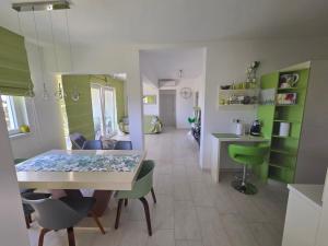 a living room with a table and chairs in a room at Apartment Mia in Rab