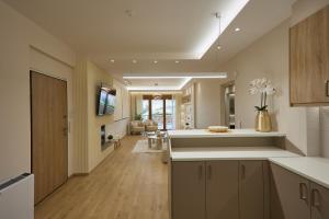 a kitchen with a counter and a living room at Elegant Villa In Vari With Private Pool in Vari
