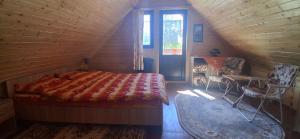 a bedroom with a bed in a wooden house at Cabana Ulmului in Vişeu de Sus