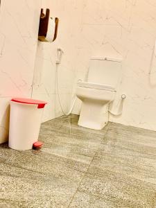 a bathroom with a toilet and a trash can at Royal Palms Resort in Arugam Bay +43 photos