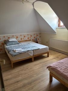 a bedroom with a large bed in a room at Vidéki Vendégház in Doboz