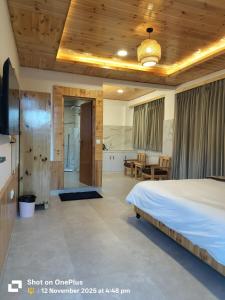 a bedroom with a large bed and a bathroom at The Snow Rock in Palchān