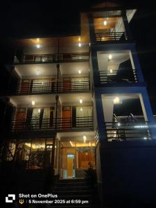 a tall building with balconies at night at The Snow Rock in Palchān
