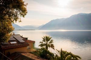 a view of a large body of water with mountains at Residenza Bettina BnB & Ferienwohnungen in Ronco sopra Ascona