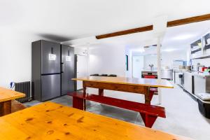 a kitchen with a wooden table and a refrigerator at ALPENHOF Mountain Lodge in Stechelberg +100 photos