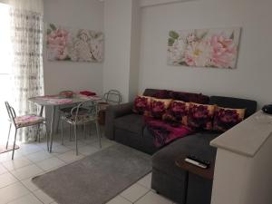 a living room with a couch and a table at Alkyona in Patra