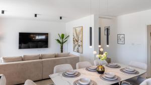 a living room with a couch and a table at Villa Amarea in Lopar