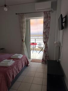 a bedroom with a bed and a view of the ocean at Alkyona in Patra