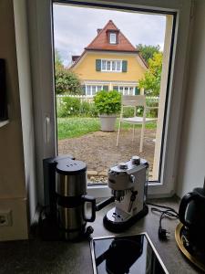 a kitchen with a stove with a view of a house at Fewo Simone - Überlingen City - in Überlingen