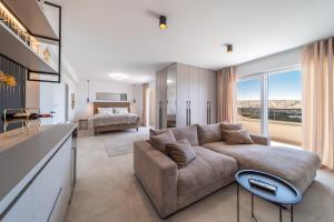 a living room with a couch and a bed at Villa Amarea in Lopar +108 photos