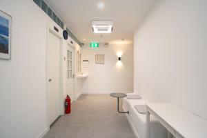 a corridor of a hospital hallway with a stool at Mac's House in Bangkok +254 photos