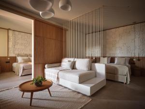 a bedroom with a bed and a couch and a table at Horizon Collection in Agios Nikolaos