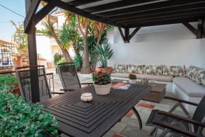 a patio with a couch and a table and chairs at The Dream House Skiathos in Skiathos