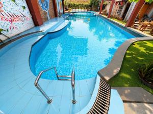 a large blue swimming pool with a slide at Gecko Backpackers Hostel in Ninh Binh