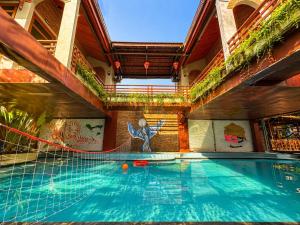 a pool in a building with an indoor swimming pool at Gecko Backpackers Hostel in Ninh Binh +59 photos