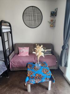 a living room with a couch and a table at Studio chaleureux sans-visà-vis in Vernon