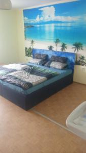 a bed in a room with a painting on the wall at Bauernwohnung in Waldmünchen