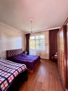 a bedroom with a bed and a window at Guest House in Sarpi in Batumi
