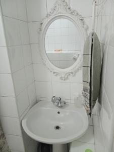 a white bathroom with a sink and a mirror at Valley Guest House in Port Elizabeth +61 photos