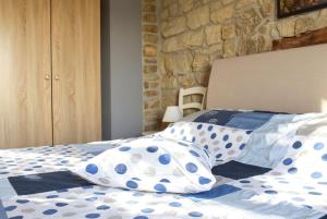 a bedroom with a bed with blue and white pillows at Kuća Zanetta sa bazenom in Buzet +71 photos