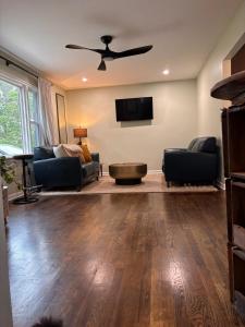 a living room with a couch and a ceiling fan at Eclectic & Fun Custom Home in Shawnee