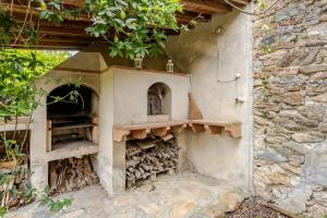 an outdoor oven with a pile of wood at House on the river in Calci