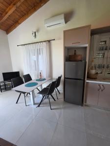 a kitchen and dining room with a table and chairs at apartment Himara SkyView in Himare +11 photos
