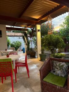 a patio with chairs and a table and a table and chairs at Ruta Del Sol in Mossoró