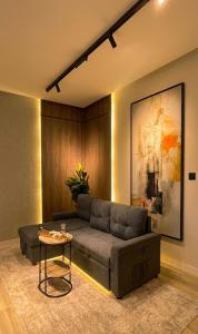 a living room with a couch and a table at هابي رومز - شقق فندقية في الخبر in Al Khobar