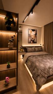 a bedroom with a large bed and some plants at هابي رومز - شقق فندقية في الخبر in Al Khobar