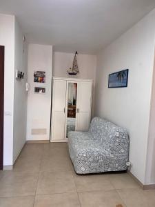 a living room with a couch and a chair at Vitti Apartment in Nettuno