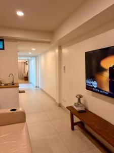 a living room with a flat screen tv on a wall at 2 Bed & 2 Bath Suite, 2nd floor in Ban Bang Toei (1)