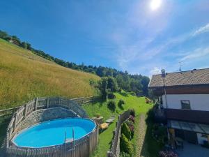 a swimming pool in a field next to a building at Lechnerhof in Plaus