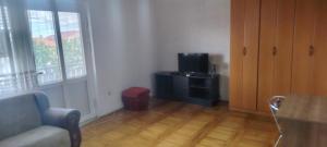 a living room with a couch and a television at stan in Podgorica