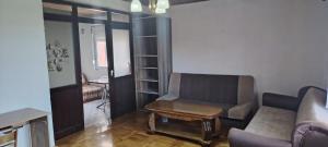 a living room with a couch and a chair at stan in Podgorica