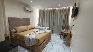 a bedroom with a bed and a television in it at Pyramids gardens guest House in ‘Ezbet `Abd el-Ḥamîd