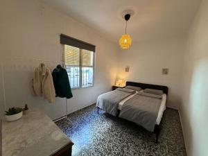 a bedroom with a bed and a window at Casa Hjort in Nerja