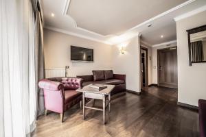 a living room with a couch and a table at Hotel Luna Mondschein in Ortisei