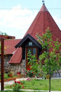 a house with a red roof and a tree at Seosko domaćinstvo Peković in Danilovgrad