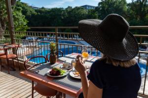 a woman sitting at a table with a plate of food at Kristal Hotel - All inclusive - Fully renovated in Golden Sands