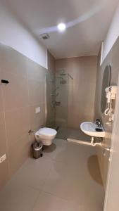 a bathroom with a toilet and a shower and a sink at Melina Rooms in Dhërmi +40 photos