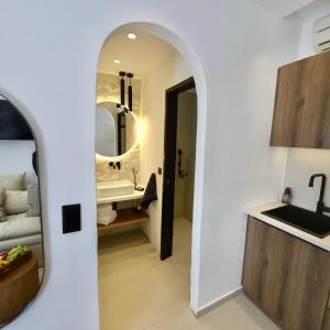 a bathroom with a sink and a mirror at Asterias Studios in Agia Anna Naxos +144 photos
