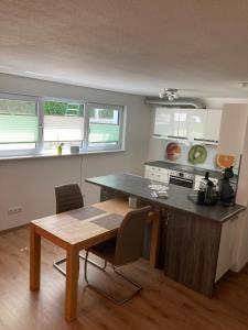a kitchen with a table and chairs in a room at Peter's Ferienwohnung Nahe Rust, Kehl, Straßburg, Offenburg in Neuried