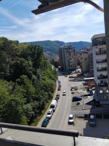 a city street with cars parked on the road at Zvezdica in Užice