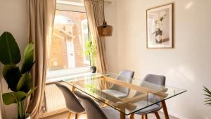 a dining room with a glass table and chairs at Modern 2-Bed Apartment in Ramsgate in Ramsgate