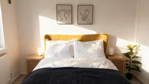 a bedroom with a bed with two pictures on the wall at Modern 2-Bed Apartment in Ramsgate in Ramsgate
