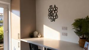 a kitchen with a counter with a plant on the wall at Modern 2-Bed Apartment in Ramsgate in Ramsgate